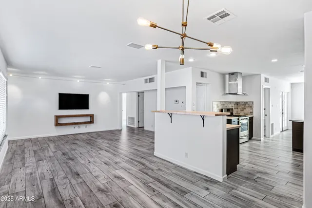 a view of kitchen with sink microwave and refrigerator
