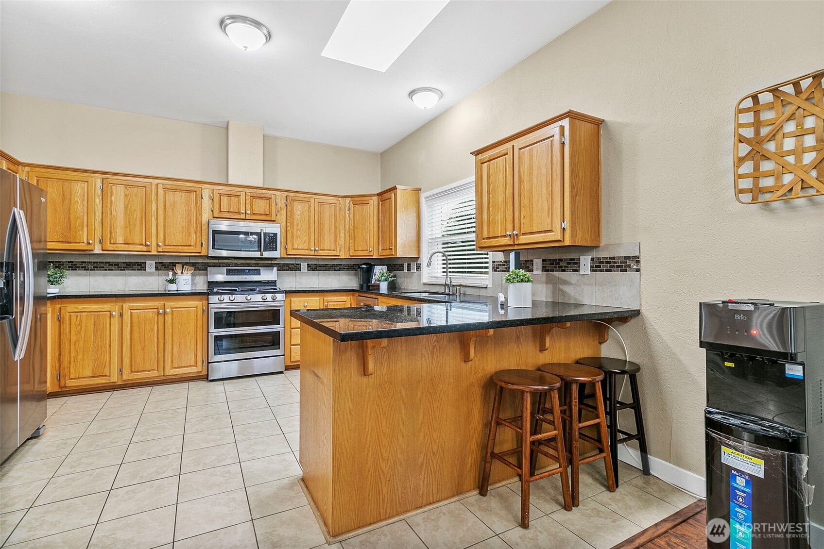4416 South 315th Street Auburn, WA 98001 - Photo 19 of 37 a kitchen with stainless steel appliances granite countertop a stove sink and cabinets