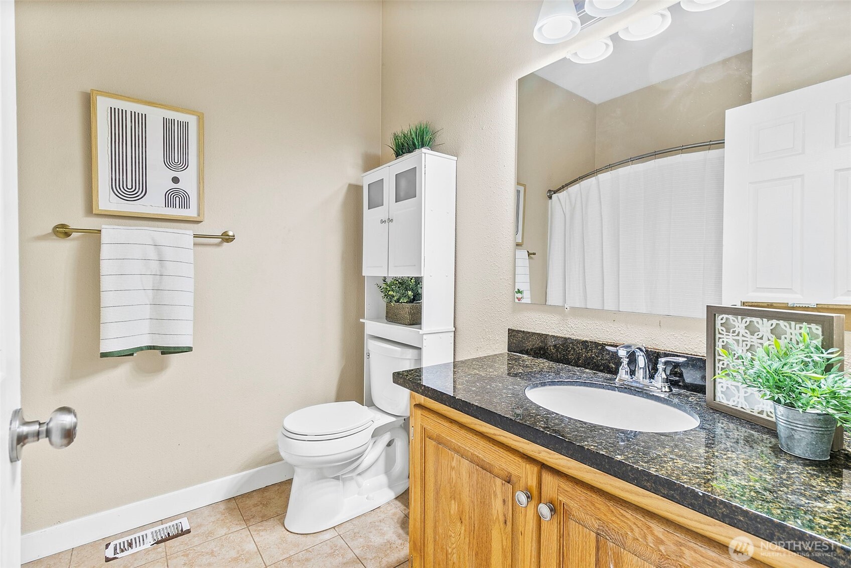 4416 South 315th Street Auburn, WA 98001 - Photo 25 of 37 a bathroom with a granite countertop sink a toilet a mirror and shower