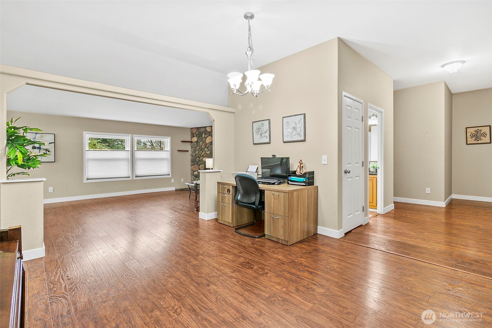 4416 South 315th Street Auburn, WA 98001 - Photo 9 of 37 a view of a kitchen with a sink wooden floor and a living room