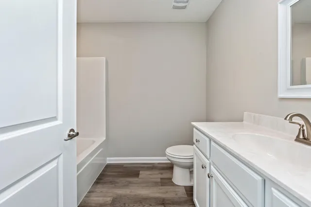 a bathroom with a sink a toilet and bathtub