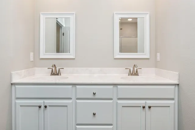 a bathroom with a sink vanity and mirror
