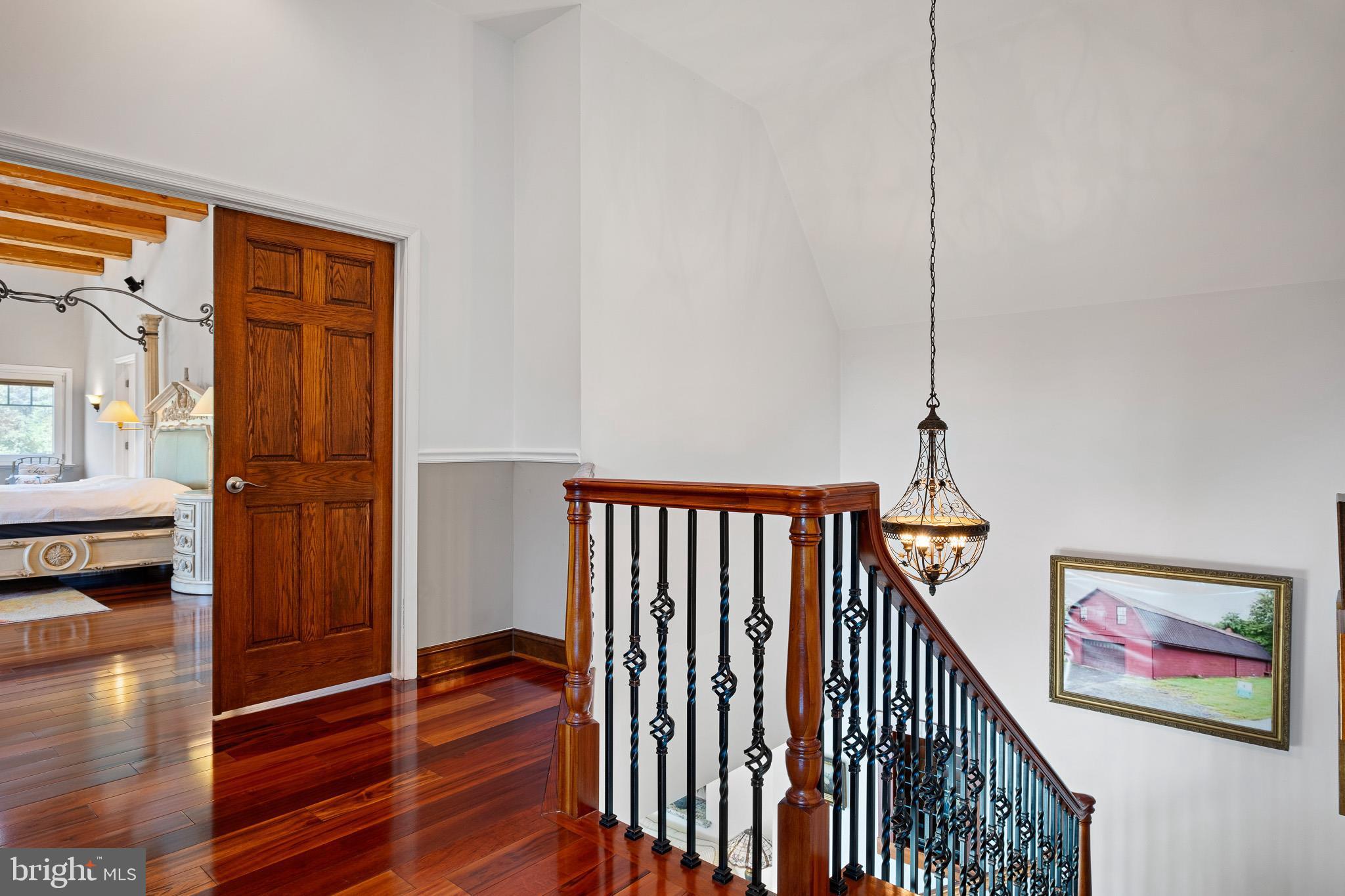 1114 Taylors Bridge Road Townsend, DE 19734 - Photo 32 of 77 a view of hallway with wooden floor and stairs