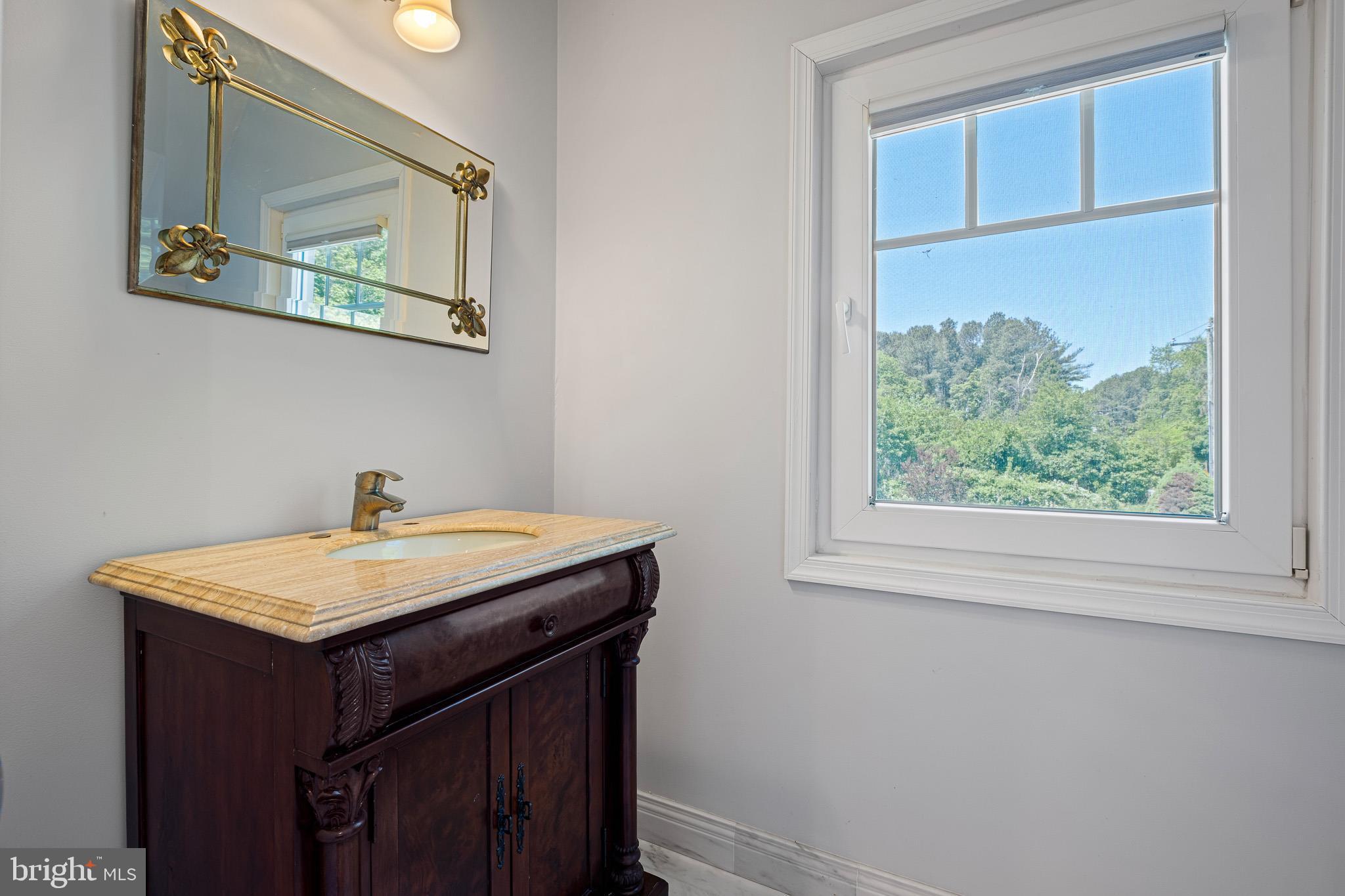 1114 Taylors Bridge Road Townsend, DE 19734 - Photo 41 of 77 a bathroom with a sink and a mirror