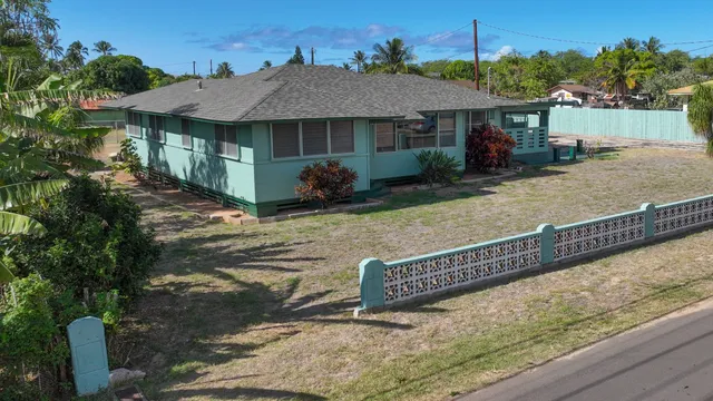 a view of a house with backyard and sitting area