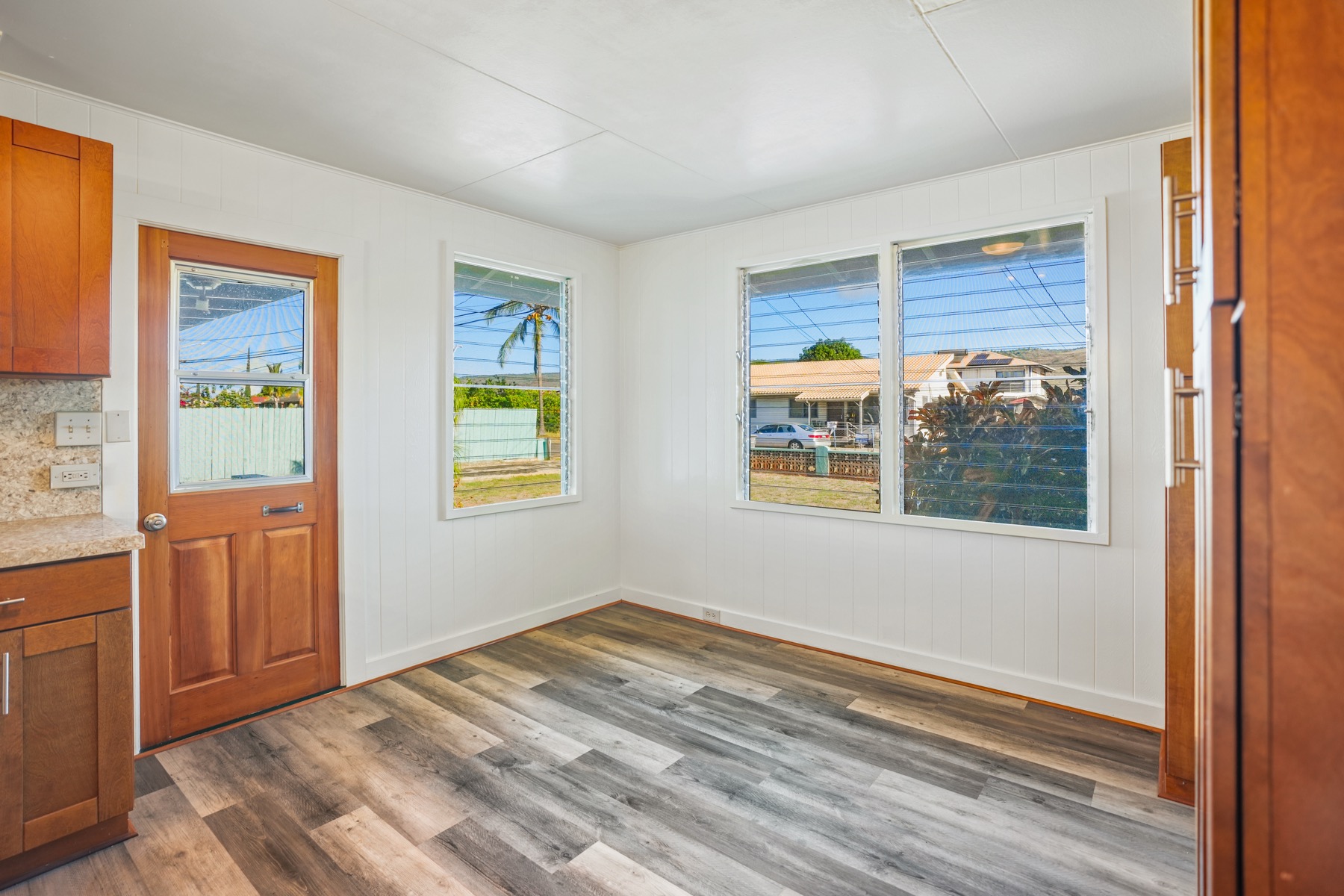 7976 Elepaio Road Kekaha, HI 96752 - Photo 11 of 30 a view of a bedroom with wooden floor and a window