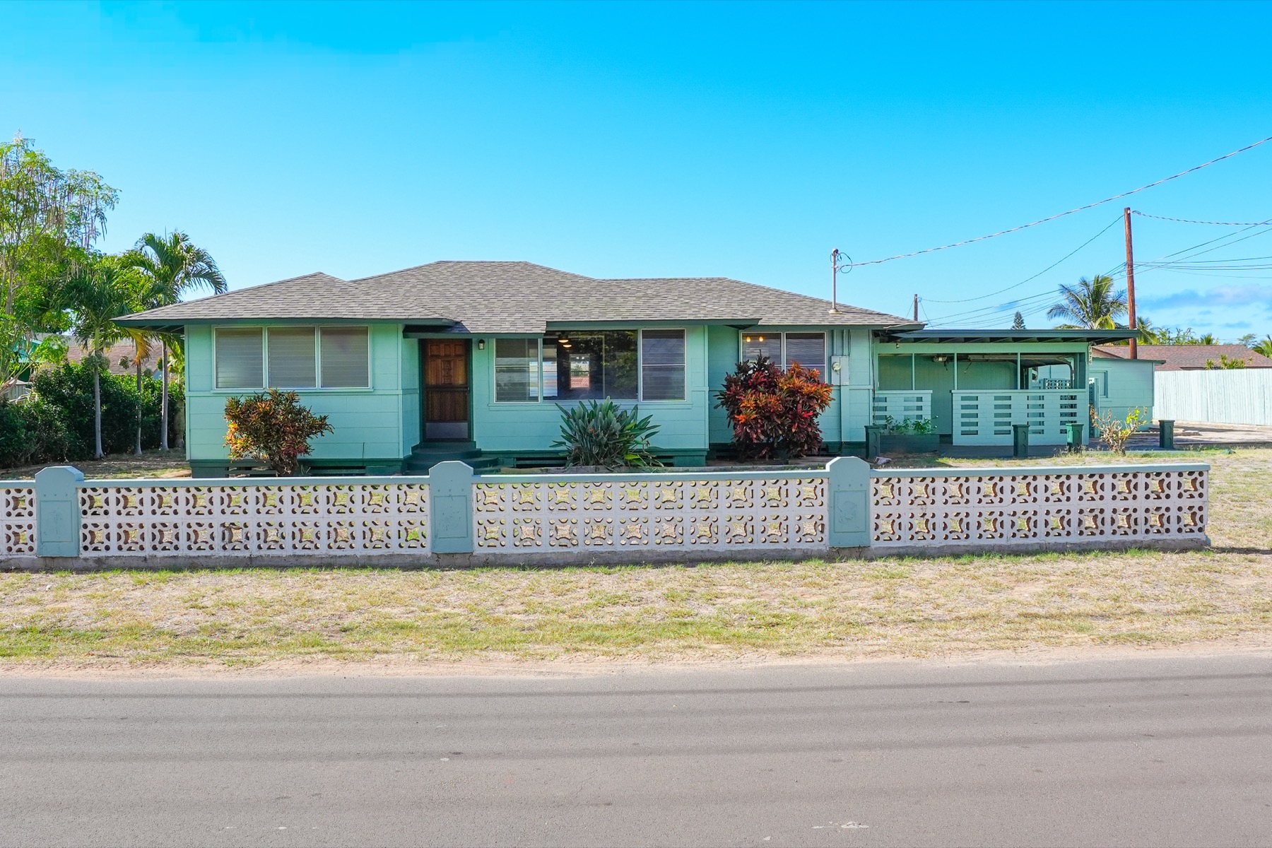 7976 Elepaio Road Kekaha, HI 96752 - Photo 15 of 30 a front view of a house with a garden and plants
