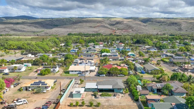 aerial view of a house with a yard