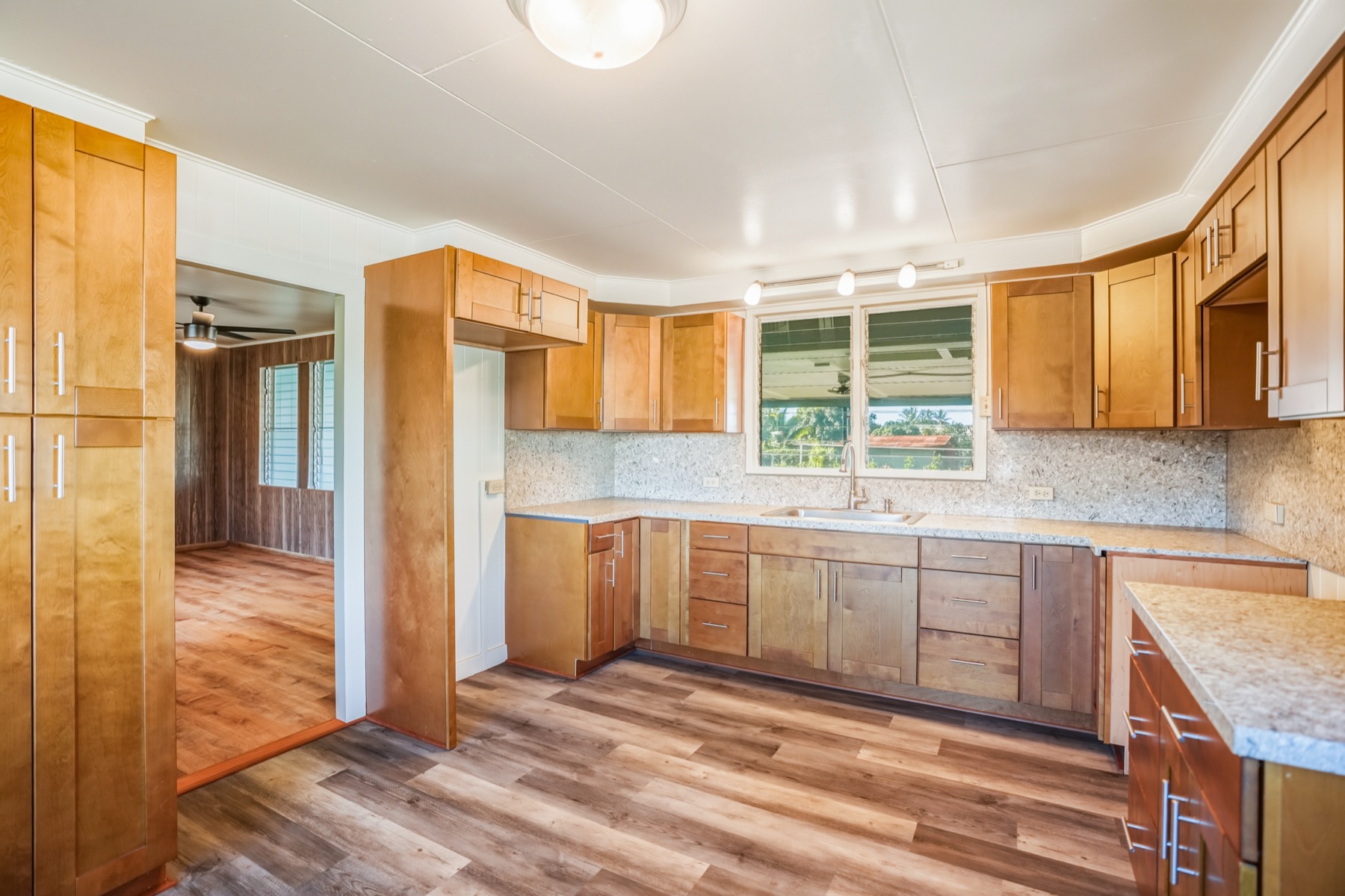 7976 Elepaio Road Kekaha, HI 96752 - Photo 25 of 30 a kitchen with stainless steel appliances granite countertop a refrigerator and cabinets