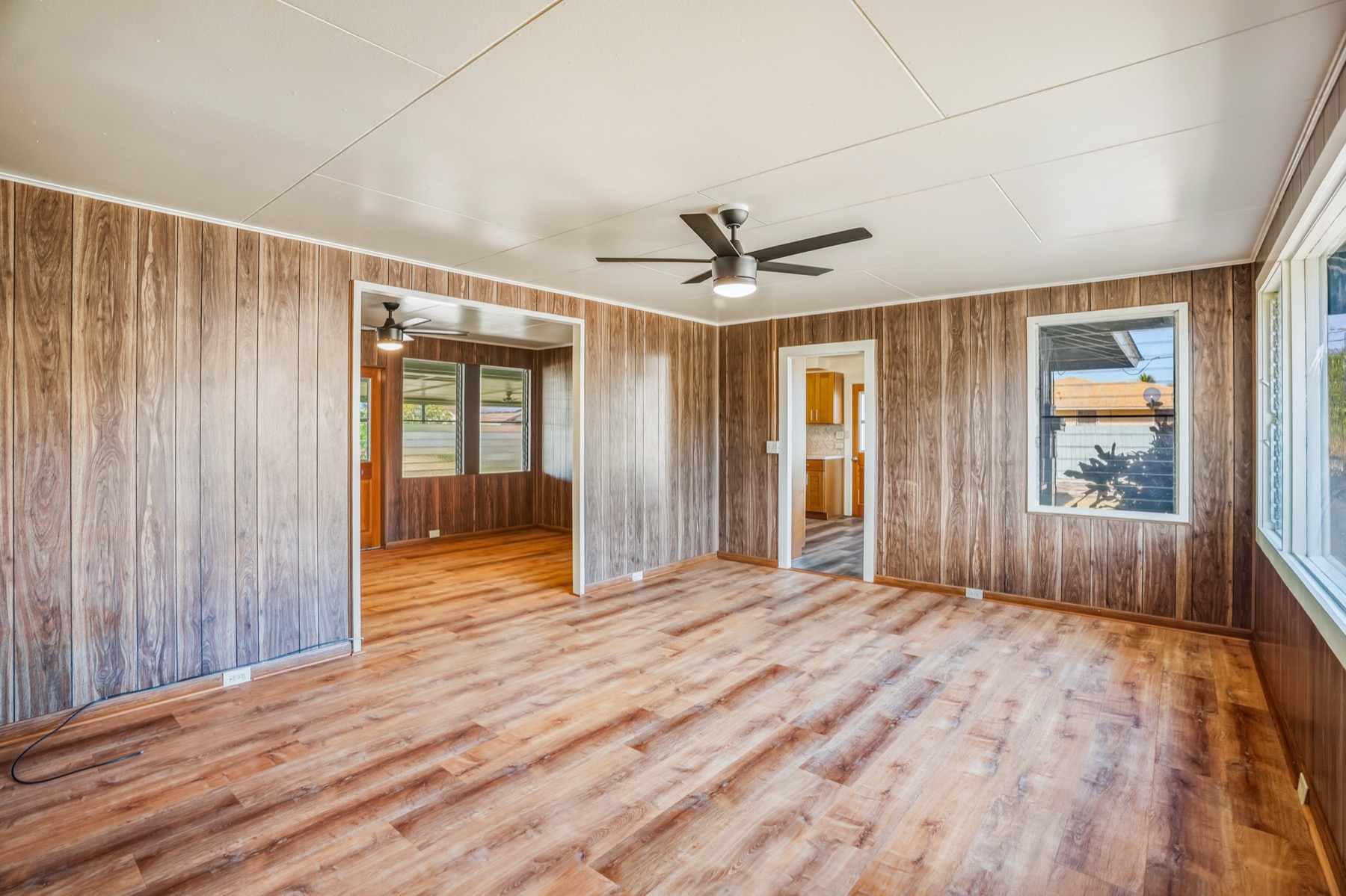 7976 Elepaio Road Kekaha, HI 96752 - Photo 27 of 30 an empty room with wooden floor and windows