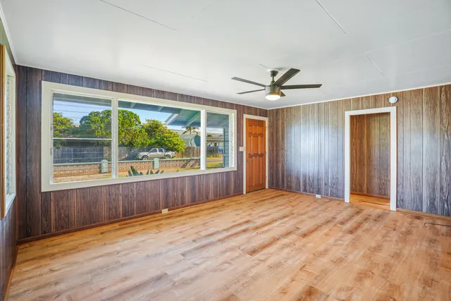 a view of a livingroom with a ceiling fan and window