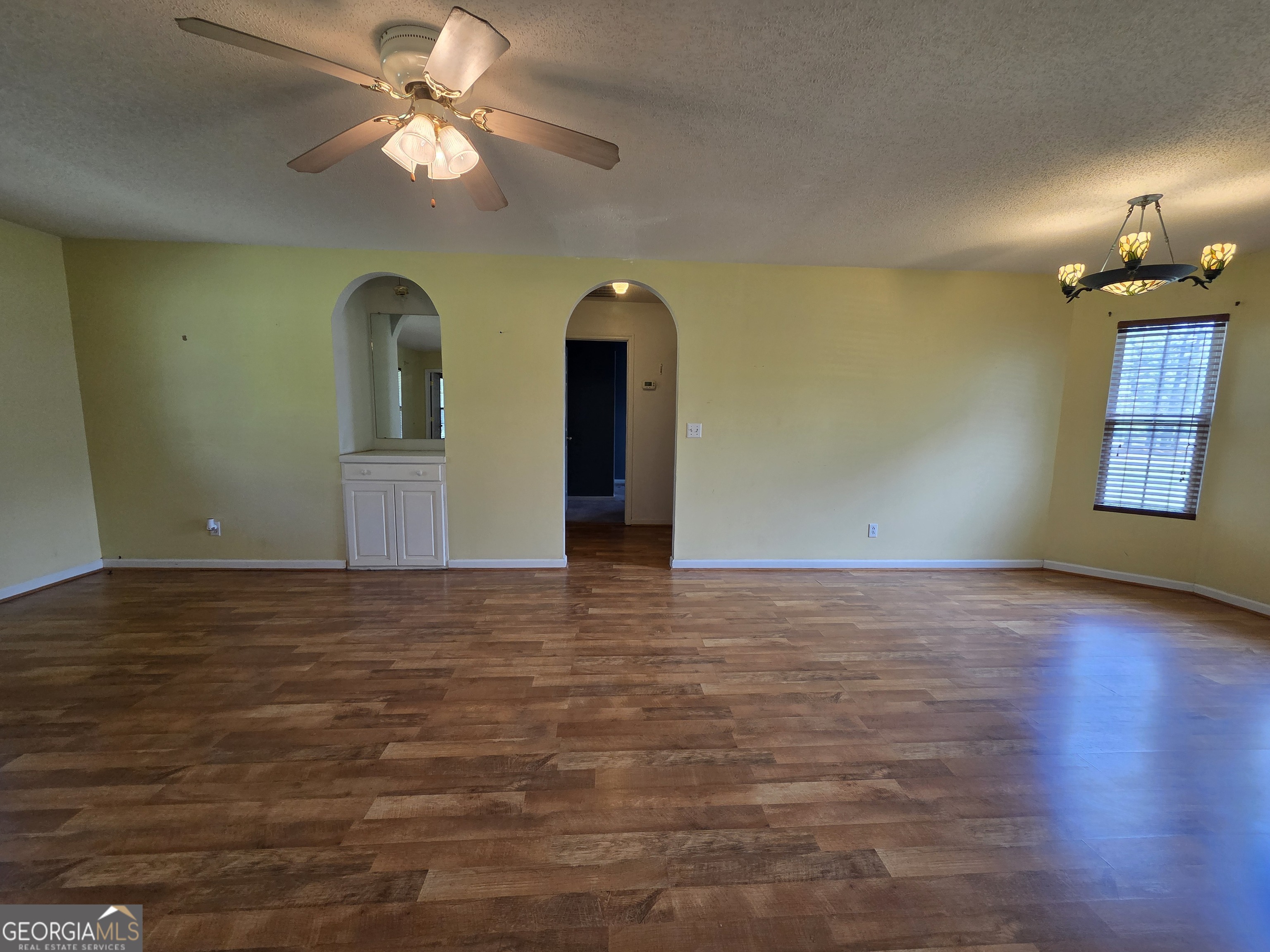 9546 Union Road Metter, GA 30439 - Photo 11 of 45 a view of a room with chandelier fan and wooden floor