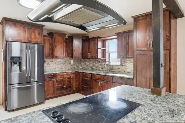 a kitchen with granite countertop a sink and a window