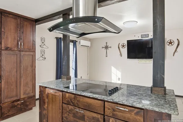 a large room with a large window and stainless steel appliances