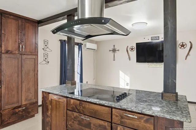 a large room with a large window and stainless steel appliances