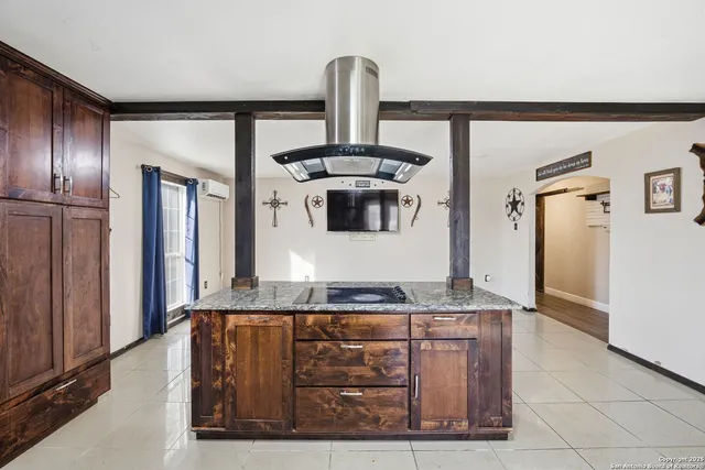an empty room with wooden floor closet and windows