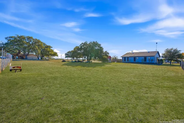 an aerial view of a house with a yard