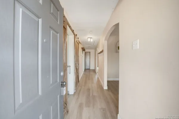 a view of a livingroom with wooden floor and furniture