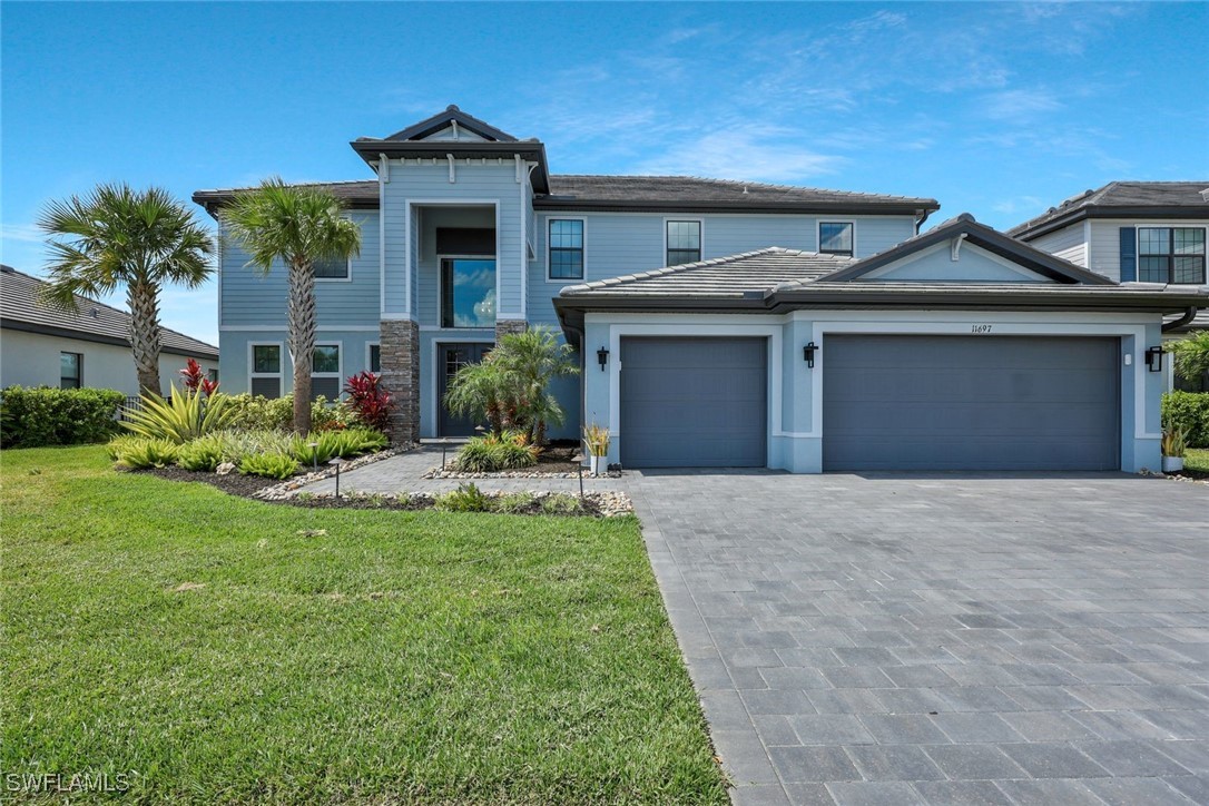 a front view of a house with a yard and garage