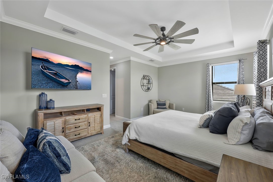 11697 Canopy Loop Fort Myers, FL 33913 - Photo 16 of 50 a bedroom with a bed and a chandelier