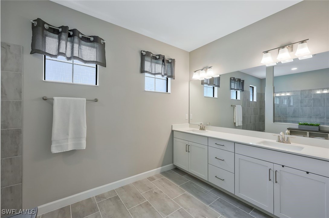 11697 Canopy Loop Fort Myers, FL 33913 - Photo 18 of 50 a spacious bathroom with a double vanity sink and a mirror