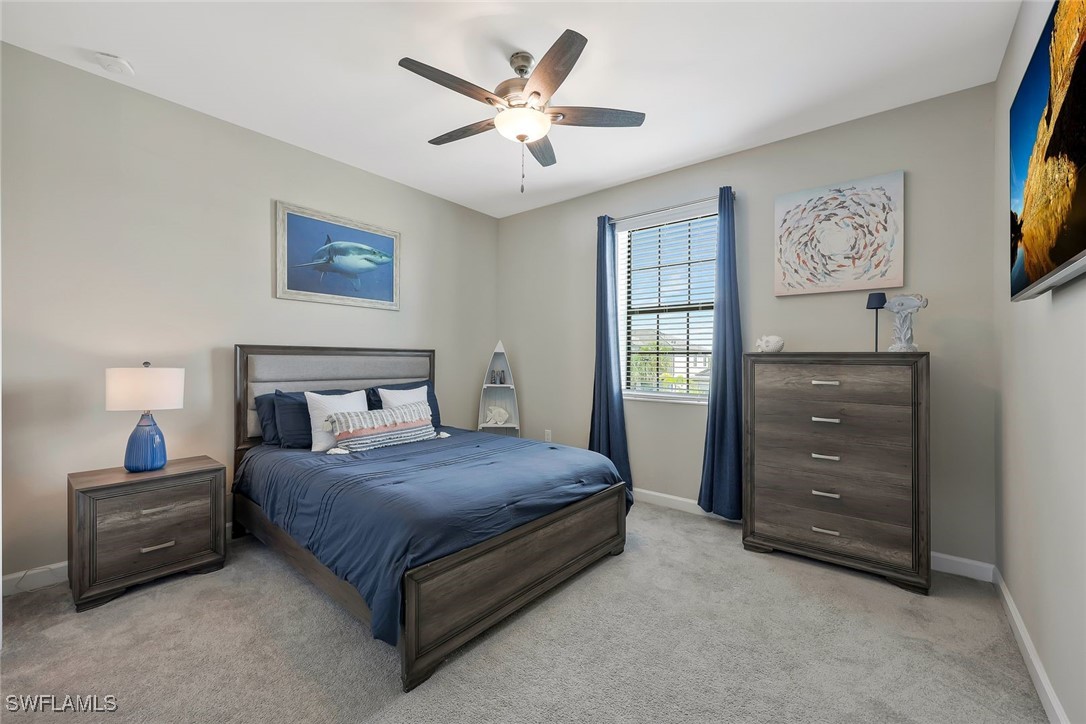 11697 Canopy Loop Fort Myers, FL 33913 - Photo 24 of 50 a bedroom with a bed a dresser and paintings on the wall