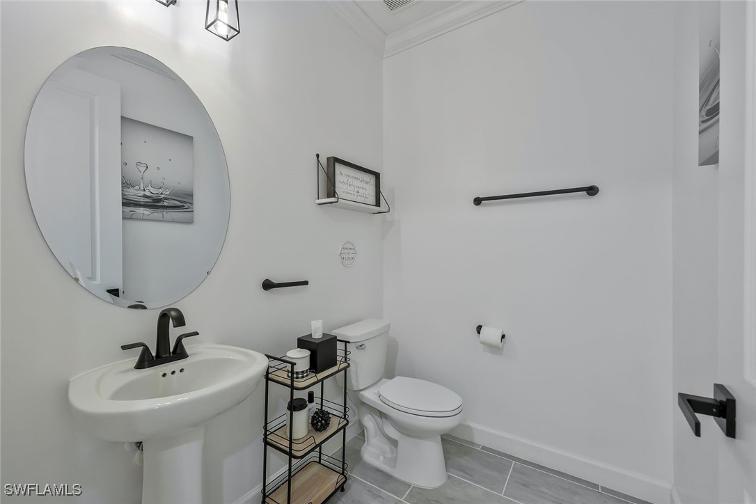 11697 Canopy Loop Fort Myers, FL 33913 - Photo 25 of 50 a bathroom with a toilet a sink and mirror