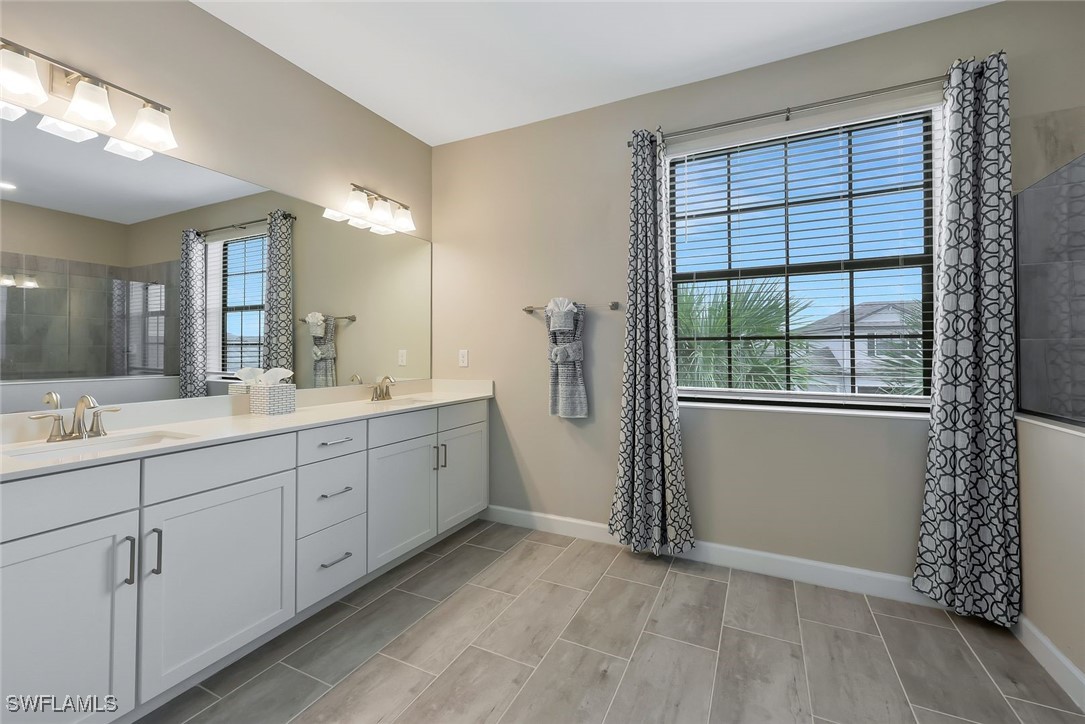 11697 Canopy Loop Fort Myers, FL 33913 - Photo 29 of 50 a spacious bathroom with double vanity and a window
