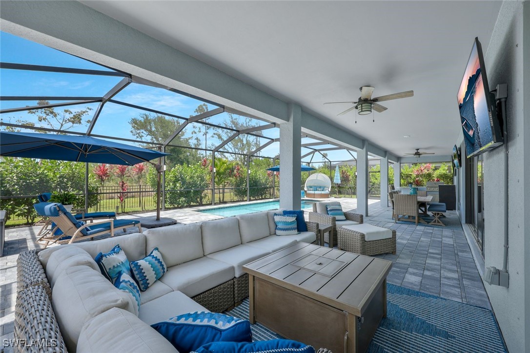 11697 Canopy Loop Fort Myers, FL 33913 - Photo 31 of 50 a living room with furniture a ceiling fan and a large window