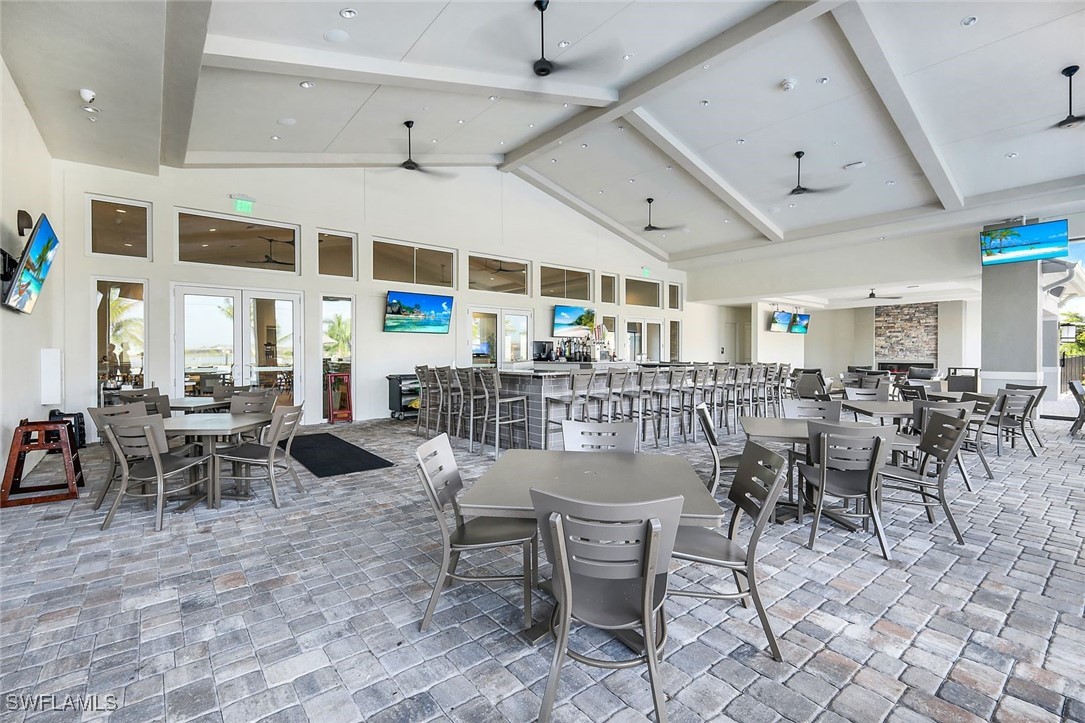 11697 Canopy Loop Fort Myers, FL 33913 - Photo 38 of 50 a outdoor space with lots of tables a chairs and white cabinets