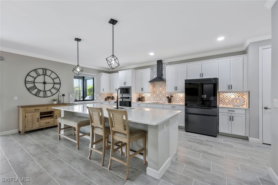 11697 Canopy Loop Fort Myers, FL 33913 - Photo 7 of 50 a kitchen with a table chairs refrigerator and cabinets