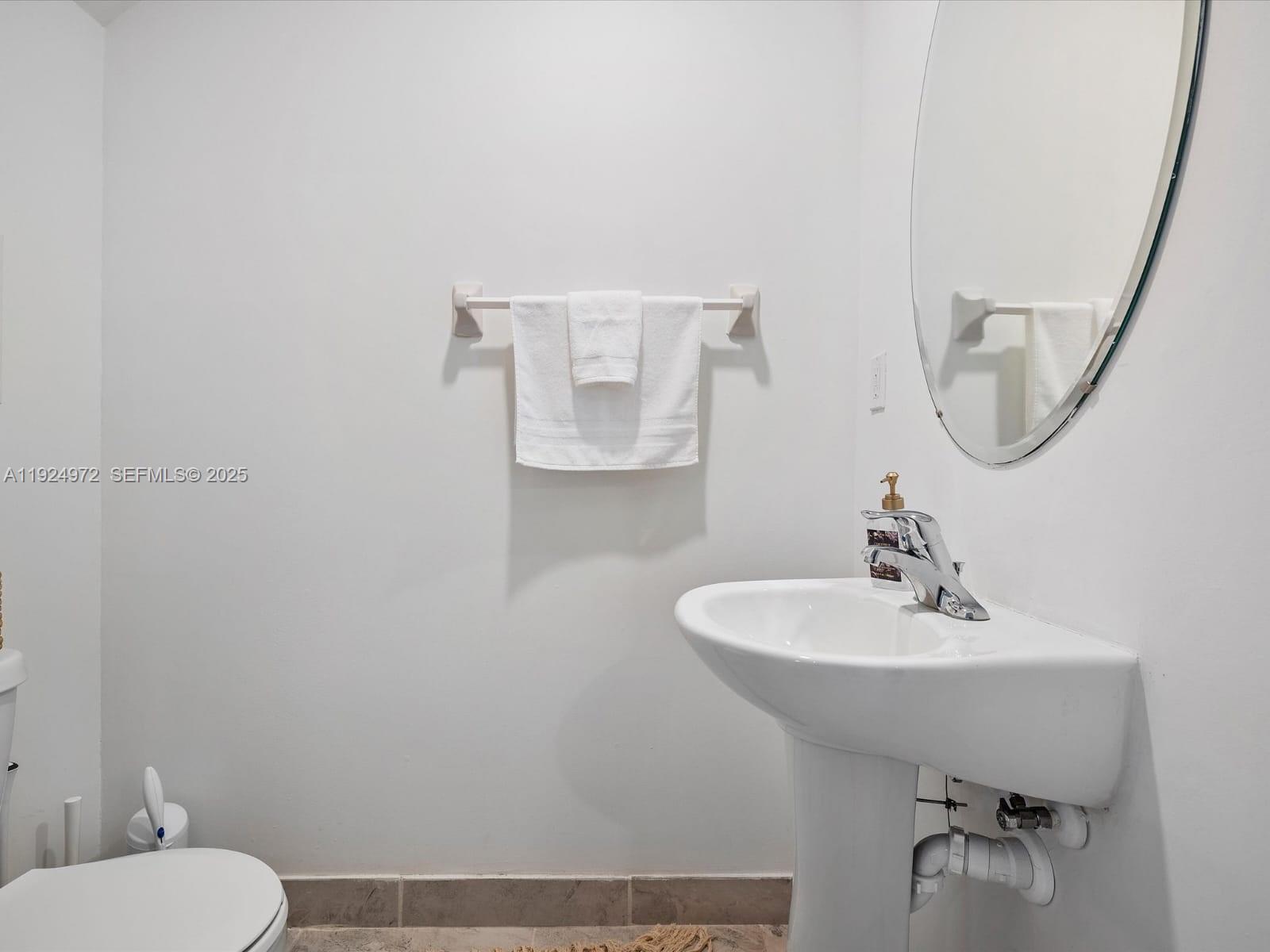 13344 Southwest 250th Street Homestead, FL 33032 - Photo 8 of 20 a bathroom with a sink a toilet and mirror