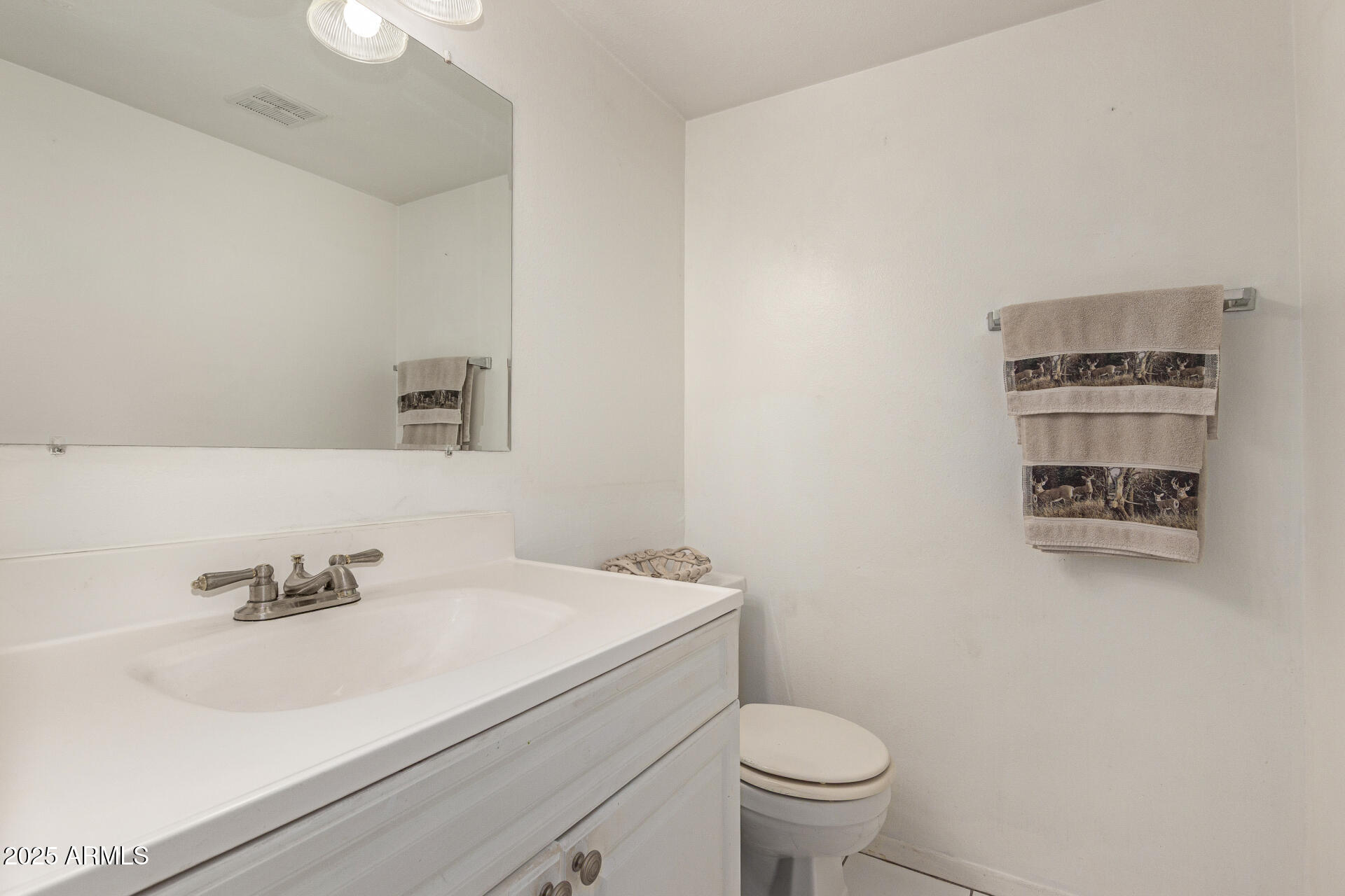 1320 East Bethany Home Road, Unit 54 Phoenix, AZ 85014 - Photo 11 of 37 a bathroom with a sink a toilet and a mirror