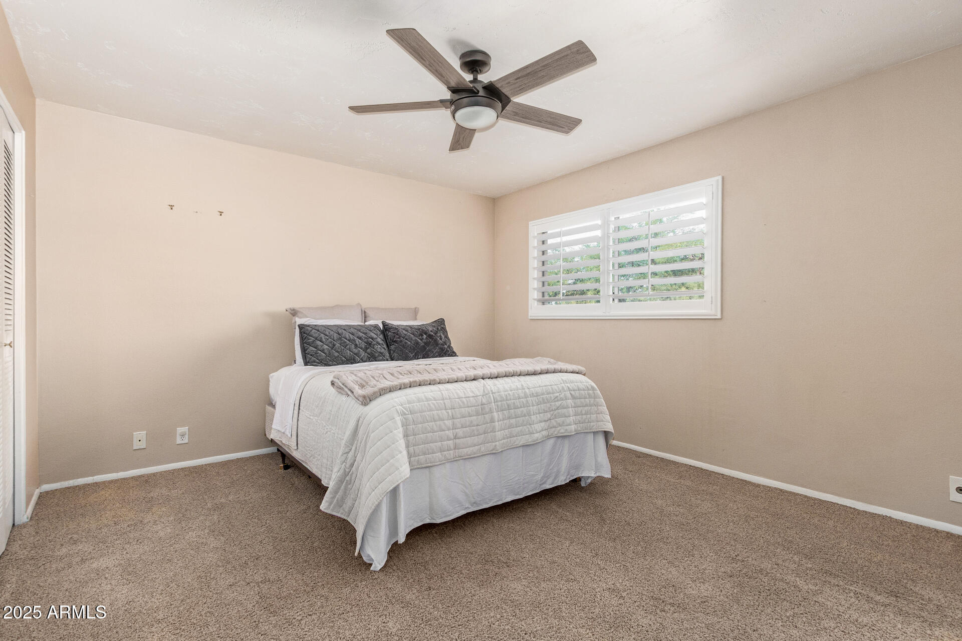 1320 East Bethany Home Road, Unit 54 Phoenix, AZ 85014 - Photo 13 of 37 a bedroom with a bed and window