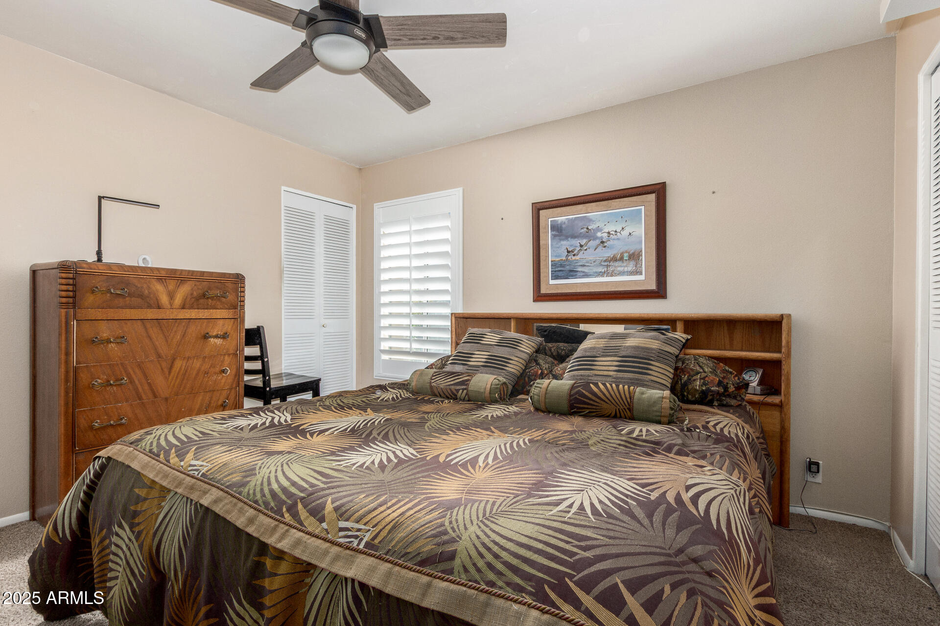 1320 East Bethany Home Road, Unit 54 Phoenix, AZ 85014 - Photo 18 of 37 a bedroom with a bed and a chandelier