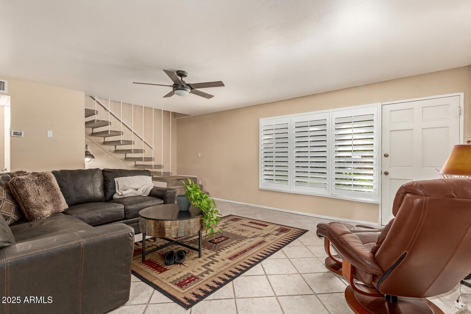 1320 East Bethany Home Road, Unit 54 Phoenix, AZ 85014 - Photo 2 of 37 a living room with furniture and a window