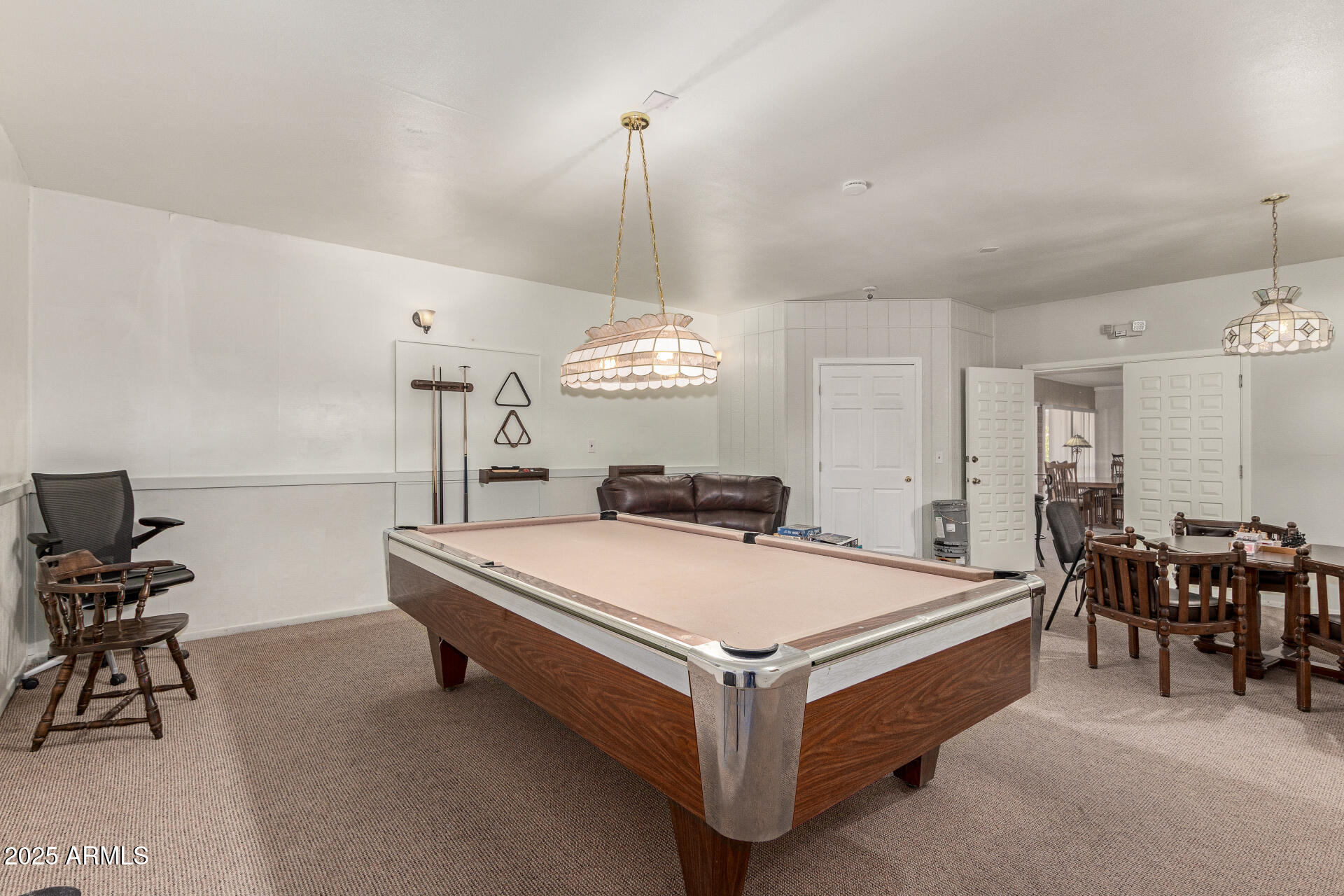 1320 East Bethany Home Road, Unit 54 Phoenix, AZ 85014 - Photo 28 of 37 a spacious bedroom with a bed and a chandelier