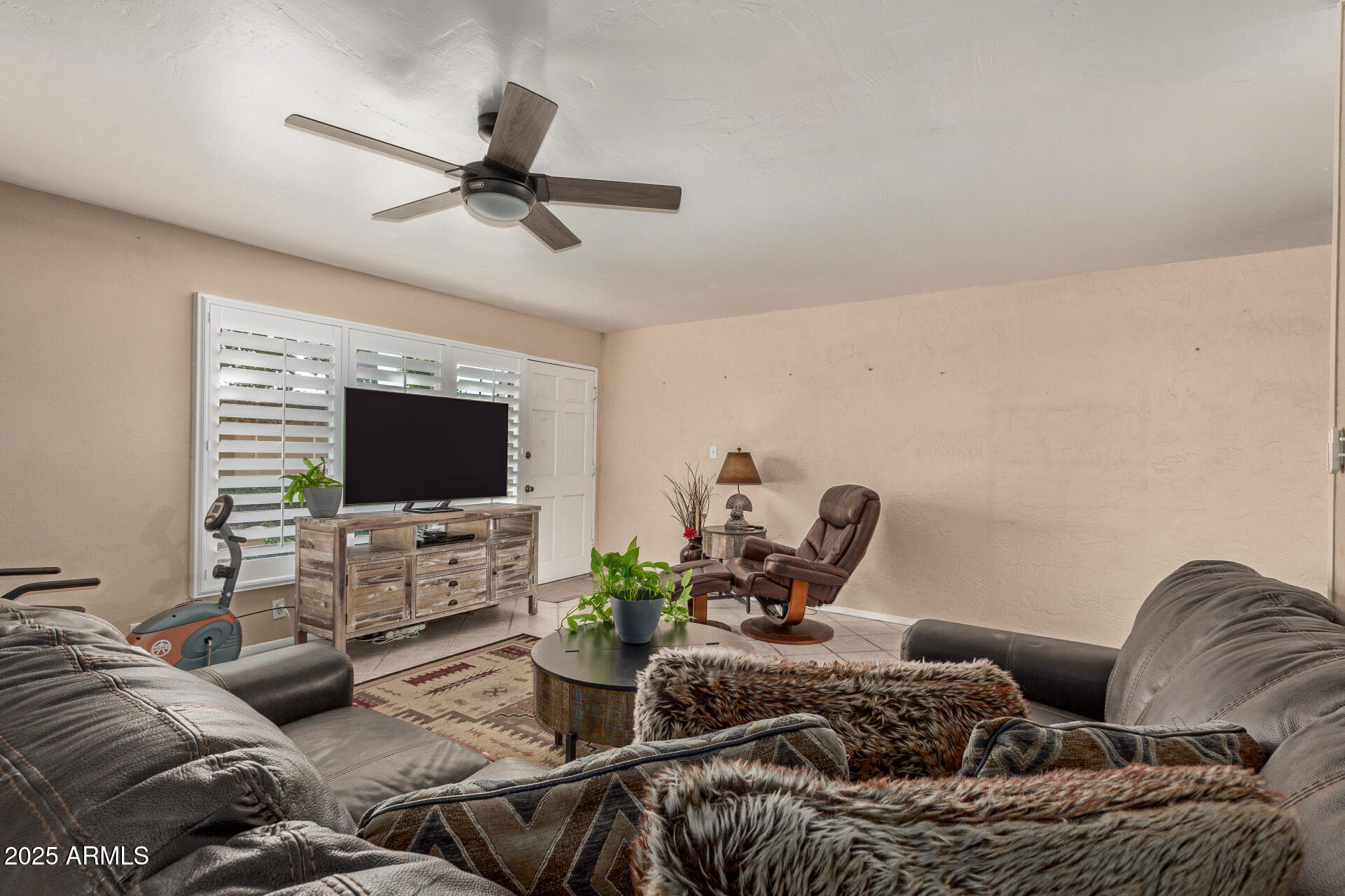 1320 East Bethany Home Road, Unit 54 Phoenix, AZ 85014 - Photo 4 of 37 a living room with furniture and a flat screen tv