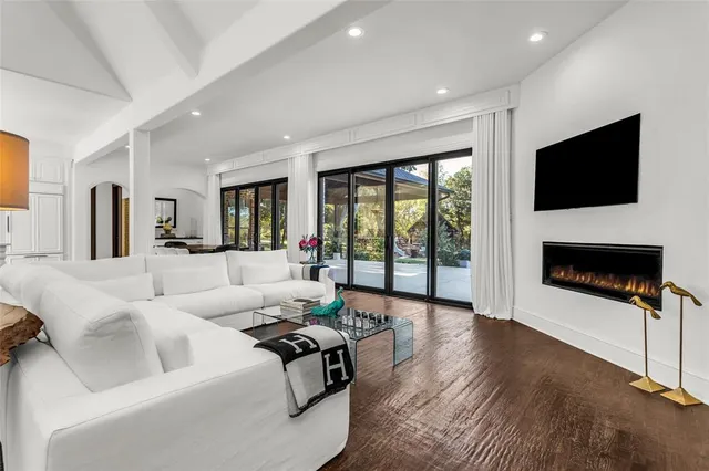 a living room with fireplace furniture and a flat screen tv