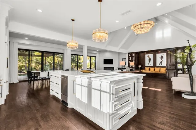 a large kitchen with a table and chairs