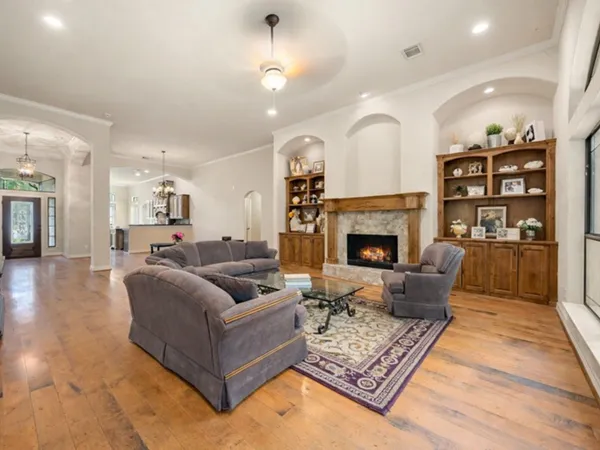 a living room with furniture fireplace and rug