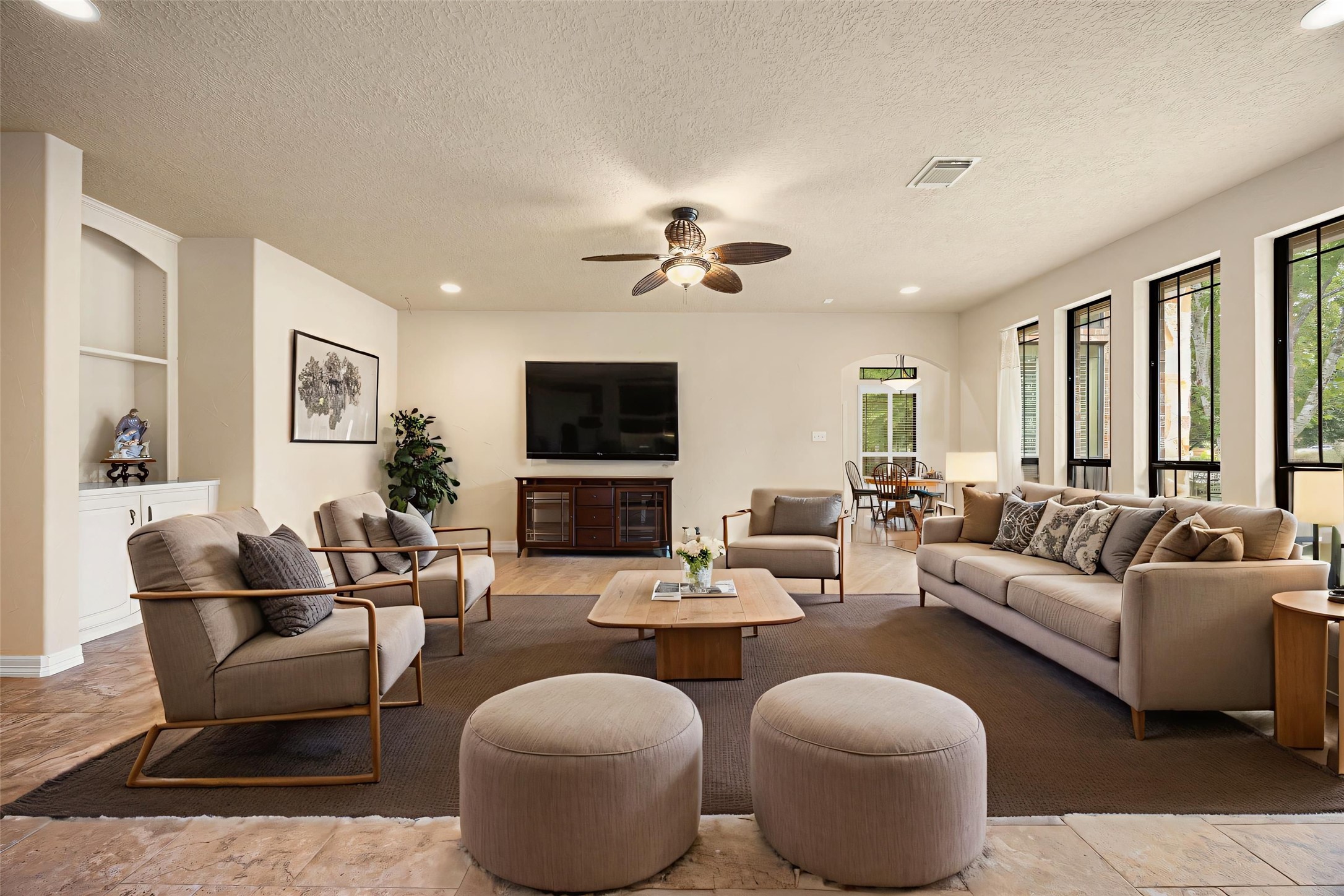 28618 Benders Crossing Drive Spring, TX 77386 - Photo 16 of 46 Expansive living room featuring hardwood flooring, recessed lighting, and a ceiling fan for added comfort. Open layout offers flexible furniture arrangements and seamless connection to the kitchen and breakfast area, making it ideal for everyday living and entertaining.