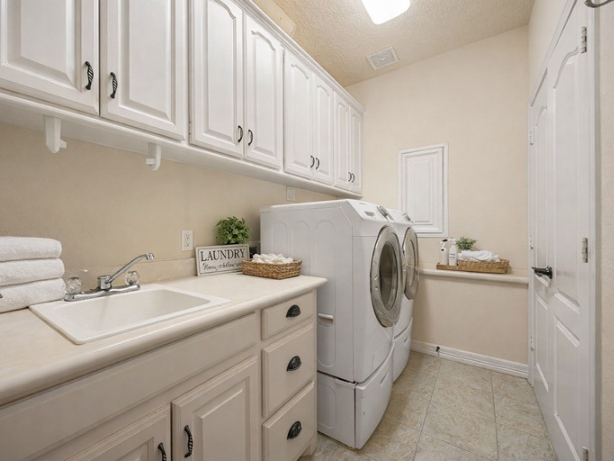 28618 Benders Crossing Drive Spring, TX 77386 - Photo 19 of 46 Spacious laundry room with extensive cabinet and closet storage, sink and the washer and dryer stay with the home!