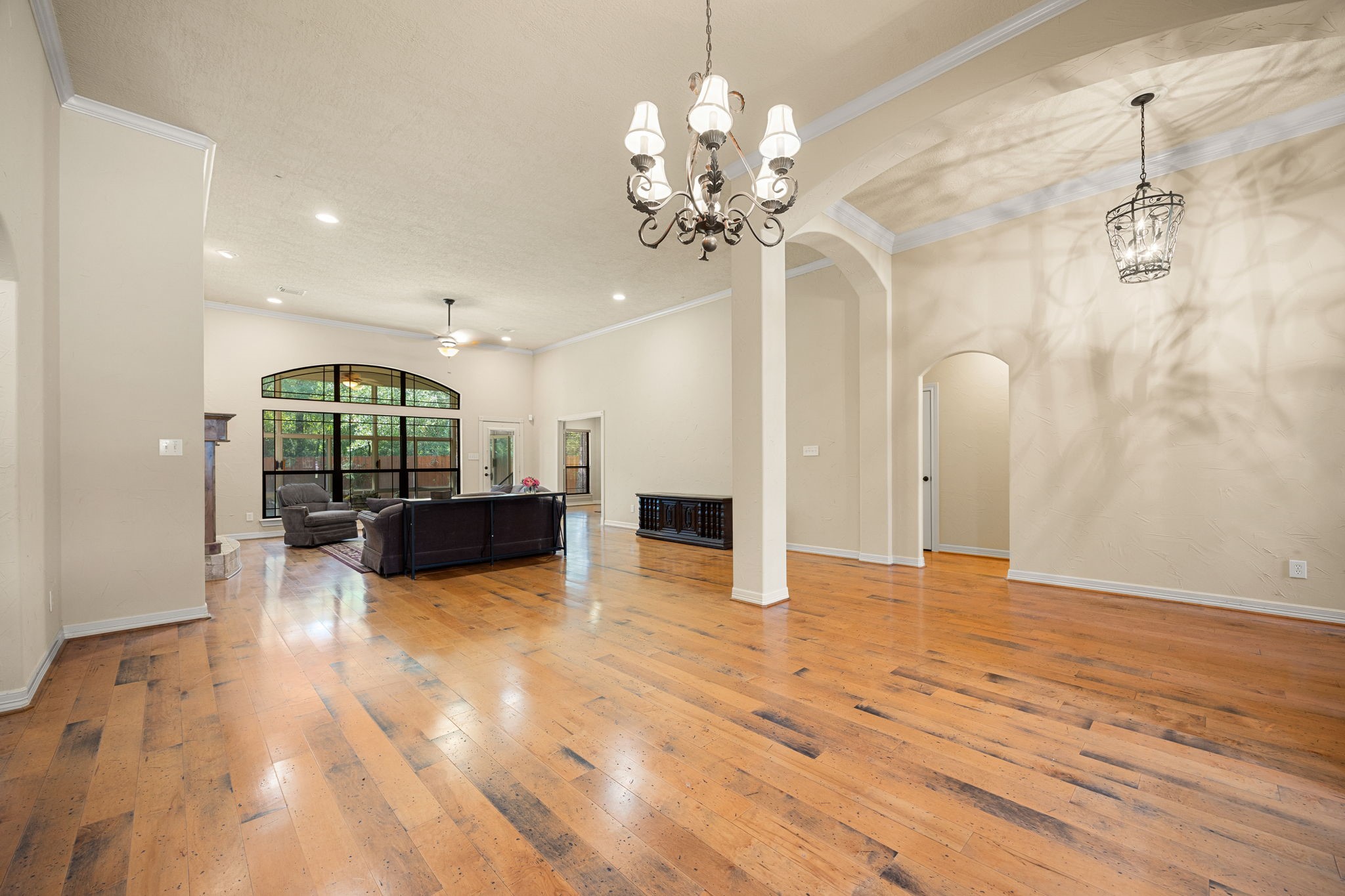 28618 Benders Crossing Drive Spring, TX 77386 - Photo 25 of 46 Elegant formal dining area featuring hardwood flooring, crown molding, graceful archways, and chandelier lighting. An open, airy layout offers flexibility for formal entertaining or everyday living.