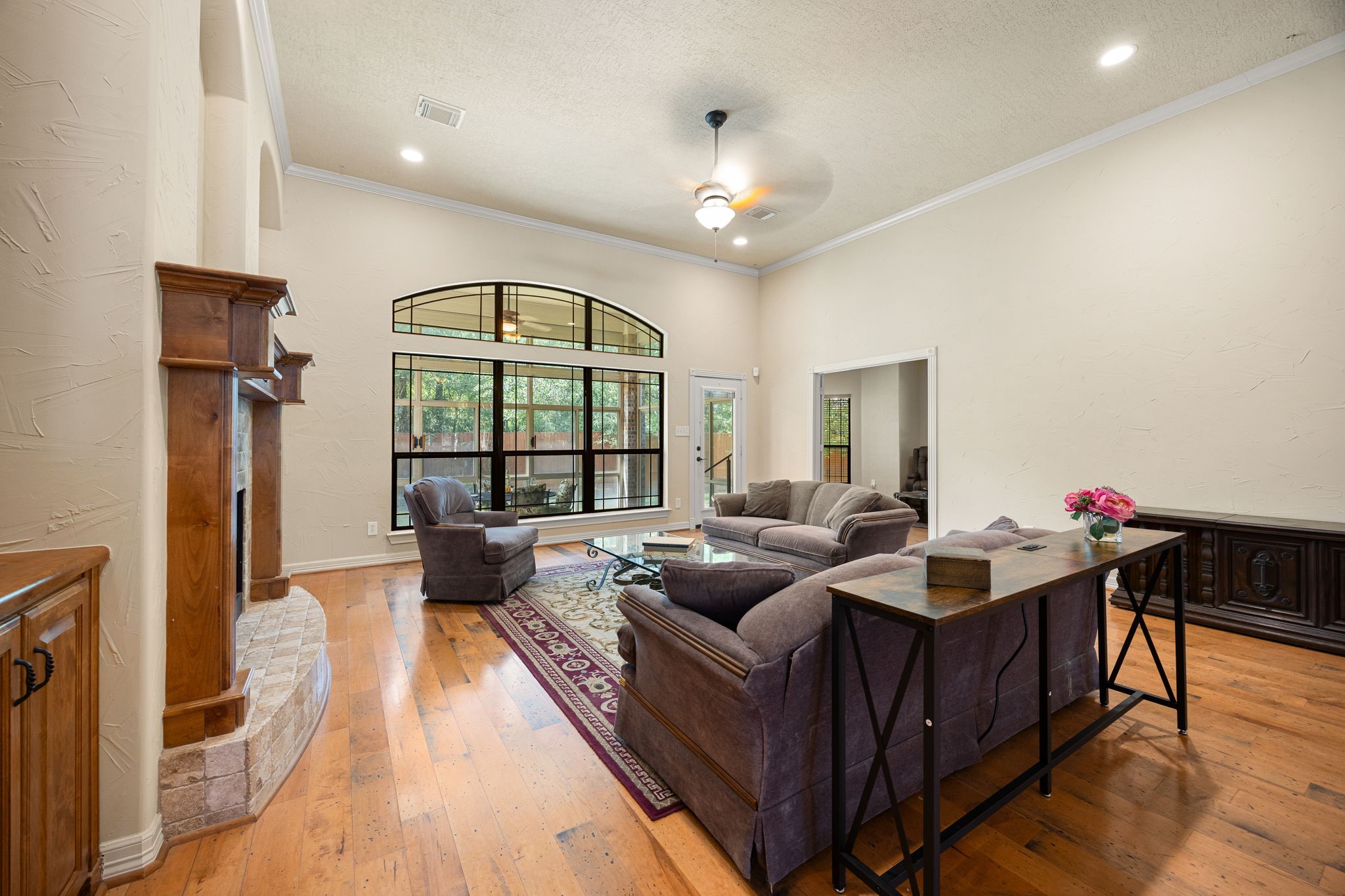 28618 Benders Crossing Drive Spring, TX 77386 - Photo 26 of 46 Light-filled living room showcasing expansive windows overlooking the backyard. A seamless connection to outdoor living enhances both comfort and entertaining options.