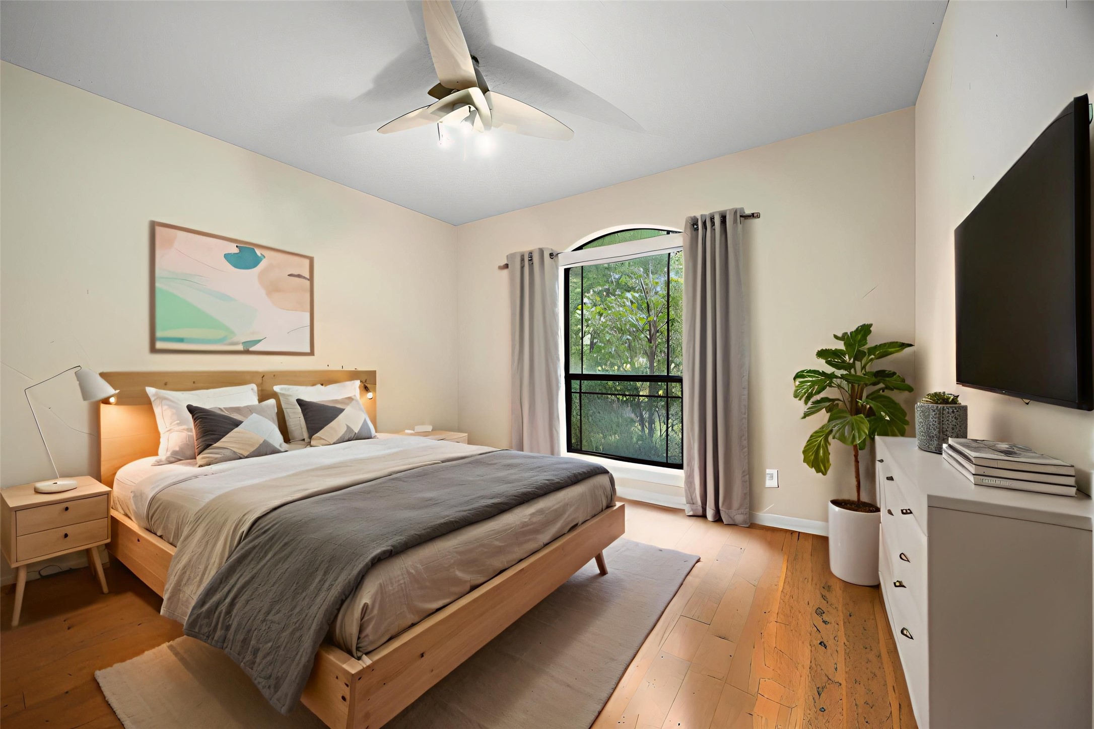 28618 Benders Crossing Drive Spring, TX 77386 - Photo 31 of 46 Bright secondary bedroom featuring hardwood flooring, a ceiling fan, and a large window overlooking the backyard. Neutral tones and natural light create a comfortable, versatile space.