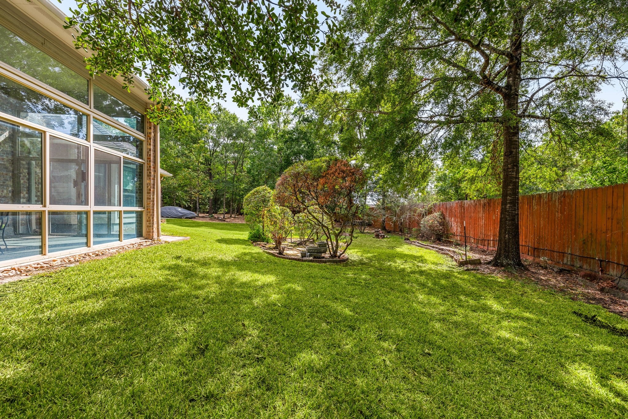 28618 Benders Crossing Drive Spring, TX 77386 - Photo 36 of 46 Alternate view of the private backyard featuring mature landscaping, shade trees, and generous green space. Ideal for outdoor enjoyment, gardening, or future outdoor living additions.