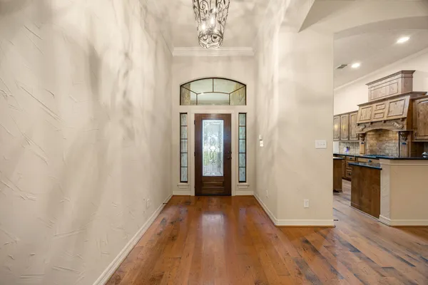 a kitchen with stainless steel appliances granite countertop a sink a stove and a refrigerator