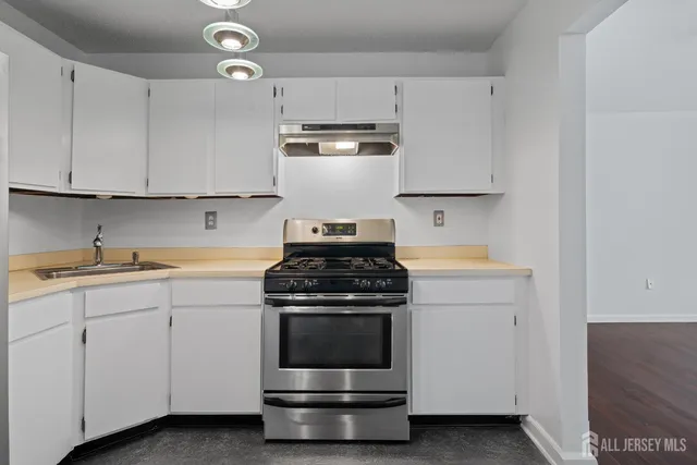 a kitchen with cabinets appliances and a sink