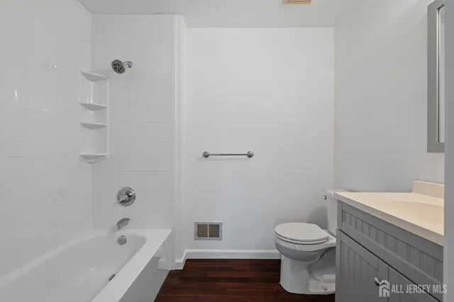 a bathroom with a toilet and a bathtub